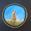 Aquarelle originale de Renaud Prégaldiny artiste peintre aquarelliste. Une marmotte veille sur son territoire en regardant le ciel. Aquarelle tendue sur cadre rond en baguette de bambou.